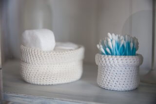 container of q tips and container of cotton balls on a counter