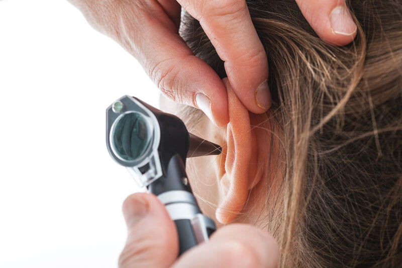 audiologist checking an ear
