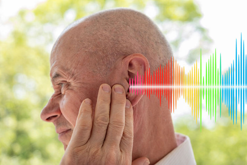 Man holding ear with sound waves symbolizing ototoxicity