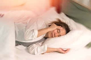 woman feeling dizzy, unable to sleep