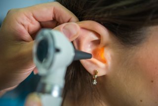 audiologist examining an ear