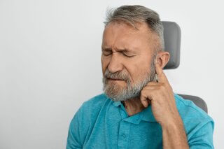 elderly man struggling with hearing